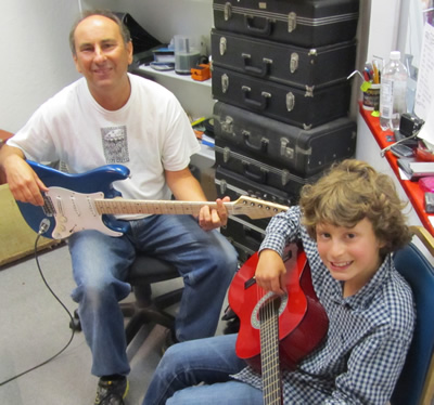 Dave Byron teaching a guitar lesson to a young student